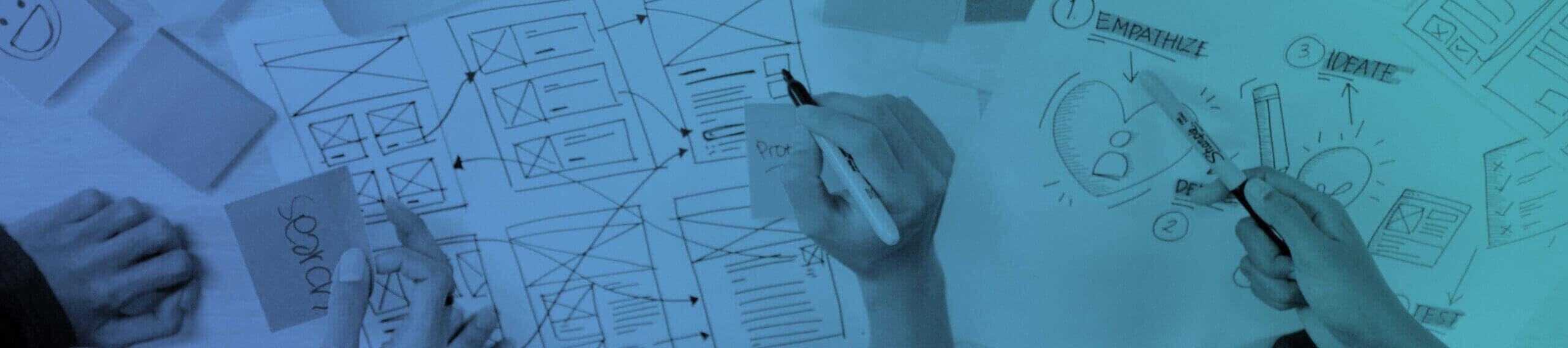 DESIGNERS IDEATING ON A USER EXPERIENCE, HANDS DRAWING WIREFRAMES. 